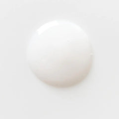 Close-up of a white pearl on a light gray background