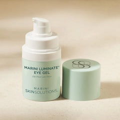 Marini Skinsolutions eye gel with pump and lid on a beige background
